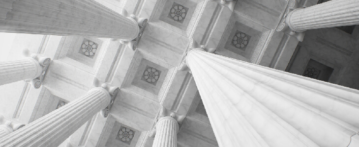 marble columns reaching toward a decorated ceiling