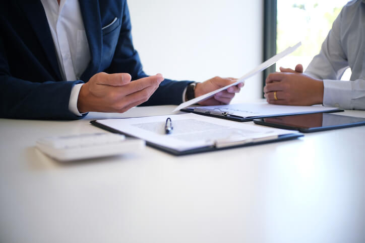 Business law attorney sitting with client