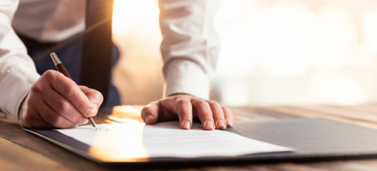 Horse owner signing a boarding contract