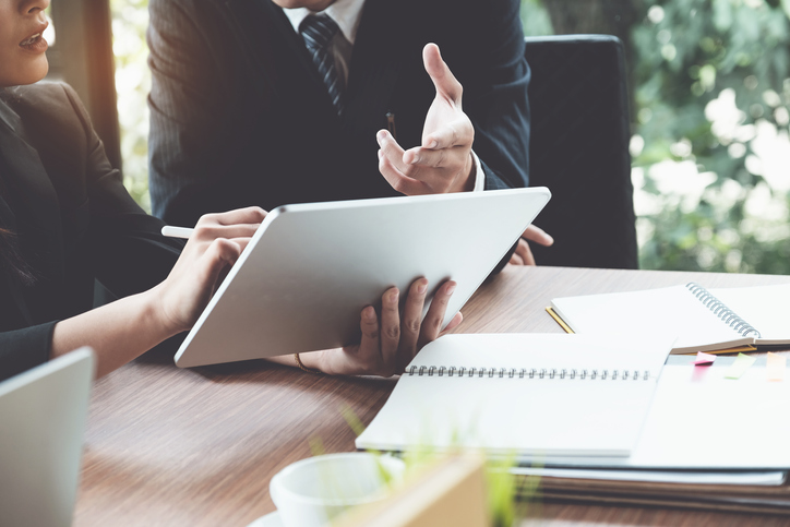 Business associates sitting with business law attorney