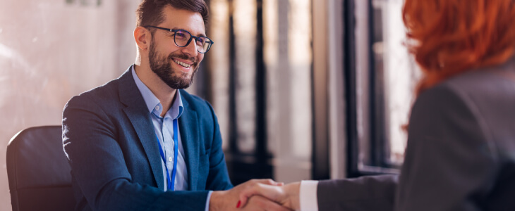 Businessman shaking hands with businesswoman.