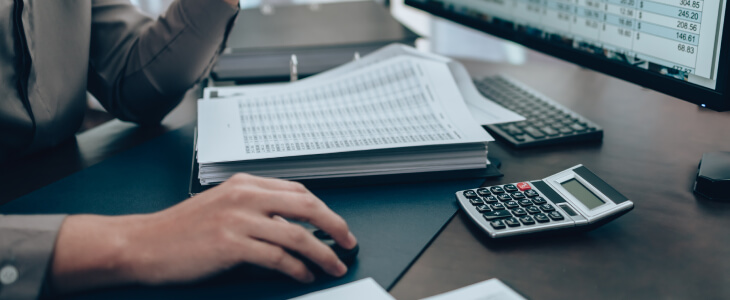 Person at a desk looking over documents