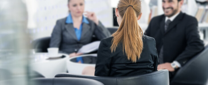 Business people sitting at a table with a mediator
