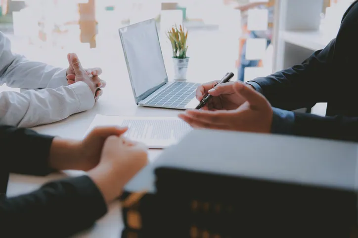 Business attorney sitting with clients