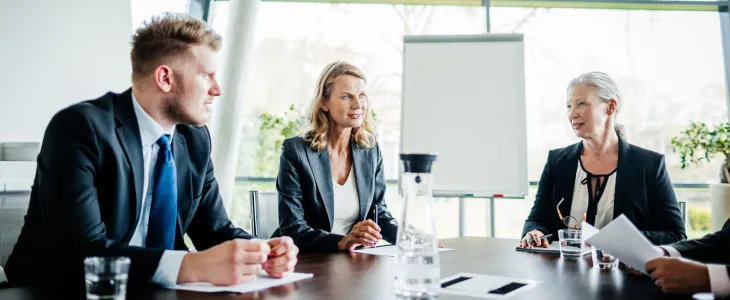 Three shareholders at a conference table